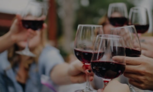 shop moldovan wine several wine glasses with red wine together saying cheers